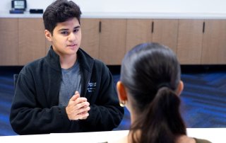 Student talking with site host employee