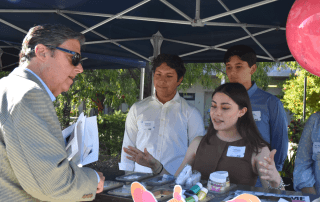 Students at Rising Innovators Expo tradeshow booth