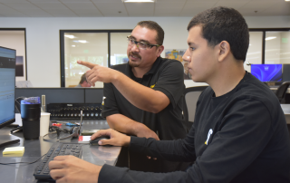 Hawthorne employee training intern on a desktop