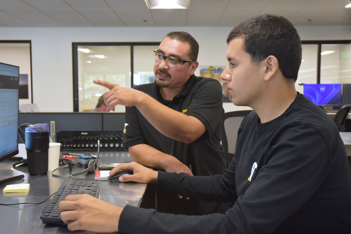 Hawthorne employee training intern on a desktop